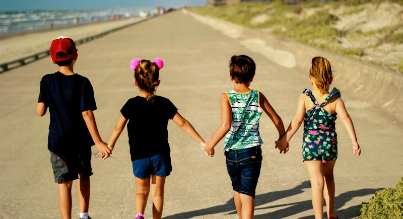 Children walking together on a boardwalk